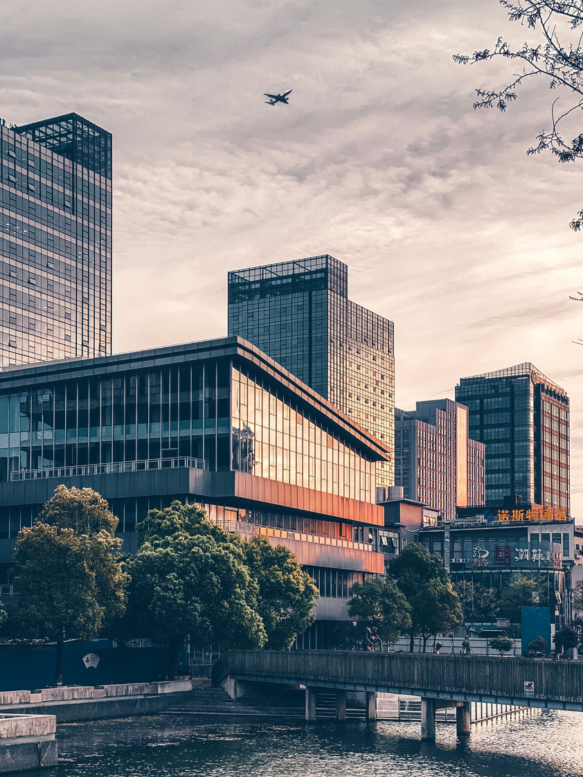 Modern city district with contemporary glass buildings on river bank